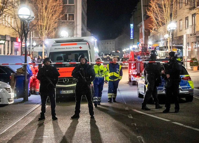 Police guard the scenery in front of a restaurant in central Hanau, Germany Thursday, Feb. 20, 2020.