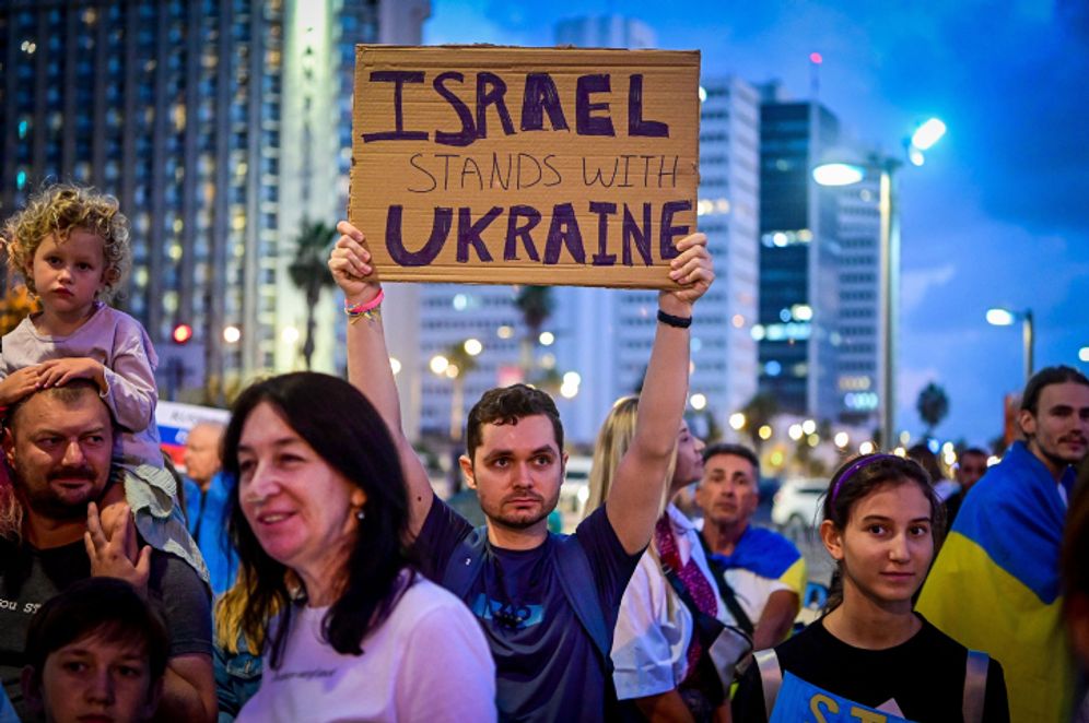 Demonstrators carry placards and flags during a protest against the Russian invasion of Ukraine, in Tel Aviv, Israel, on October 13, 2022.