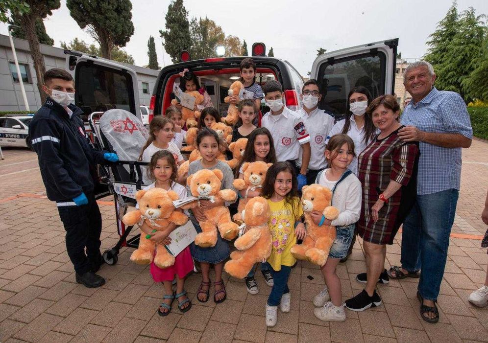 The children posing with their teddy bears outside the Azrieli Faculty of Medicine, Safed, Israel, May 2, 2022.