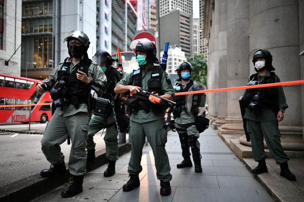 Riot police officers stand guard ahead of a pro-democracy march in the Central district of Hong Kong on June 9, 2020.