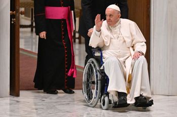 Pope Francis arrives on wheelchair during the audience to the Participants to Plenary Assembly of the International Union of Superiors General on May 5, 2022 in the Paul VI hall at the Vatican.