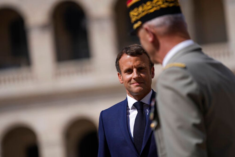 French President Emmanuel Macron (left) attends a farewell ceremony for the French armed forces chief of staff, Gen. Francois Lecointre at the Invalides monument in Paris, on July 21, 2021.