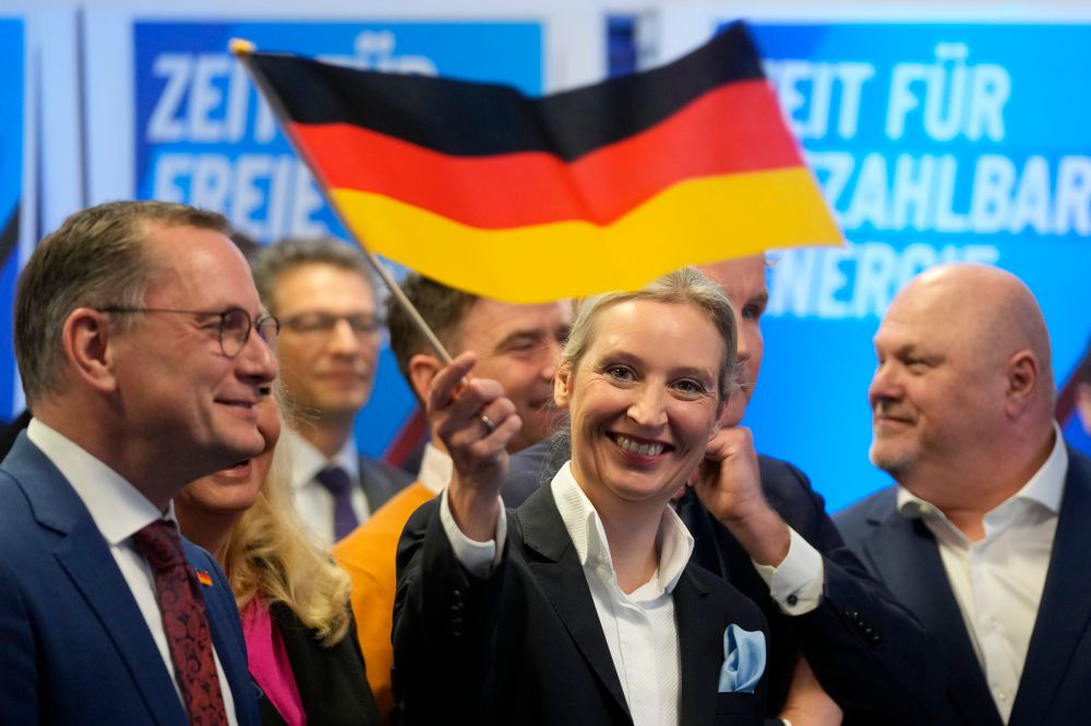 Leader of far right AfD Alice Weidel waves a German flag at the AfD party headquarters in Berlin, Germany