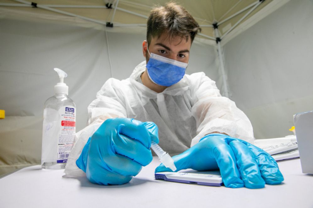 Worker take a Covid rapid antigen test from Israelis, at a Magen David Adom testing center in Lod, Israel, on October 17, 2021.