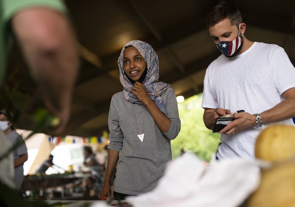 Rep. Ilhan Omar (D-MN) campaigns with her husband Tim Mynett (right) at the Richfield Farmers Market in Richfield, Minnesota, on August 8, 2020.