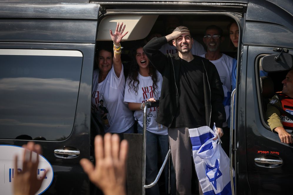 Photo by Yossi Aloni/Flash90 Released hostage Guy Gilboa-Dalal waves the Israeli flag as he arrives to Beilinson hospital, October 13, 2025.