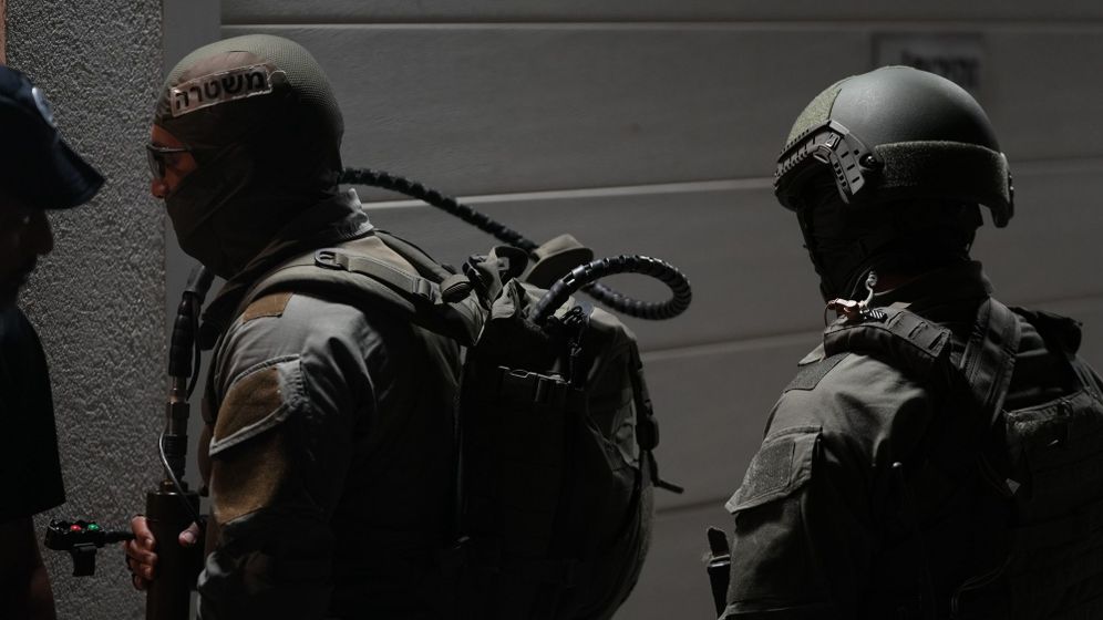 Police forces conduct a raid on a house, August 2026