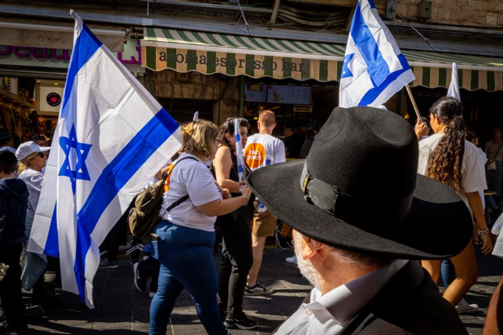 Supporters of Yesh Atid hold flags at the Mahane Yehuda market in Jerusalem.