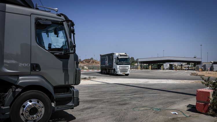 Trucks loaded with humanitarian aid wait at the Kerem Shalom crossing before entering the Gaza Strip from southern Israel. August 12, 2026 