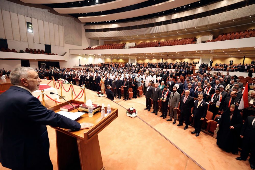 Mahmoud al-Mashhadani, left, the longest serving representative, opens the first parliament session, in Baghdad, Iraq, January 9, 2022.