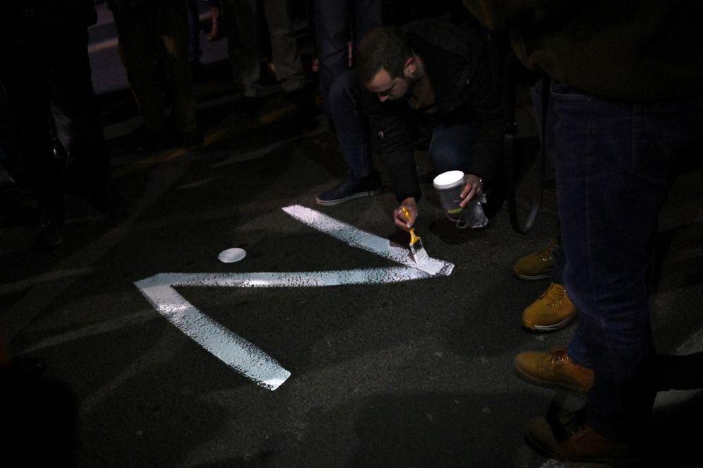 A protester paints the "Z" sign on a street, in reference to Russian tanks marked with the letter, during a rally organised by Serbian right-wing organizations in support of Russian invasion in Ukraine, in Belgrade, Serbia, March 4, 2022.