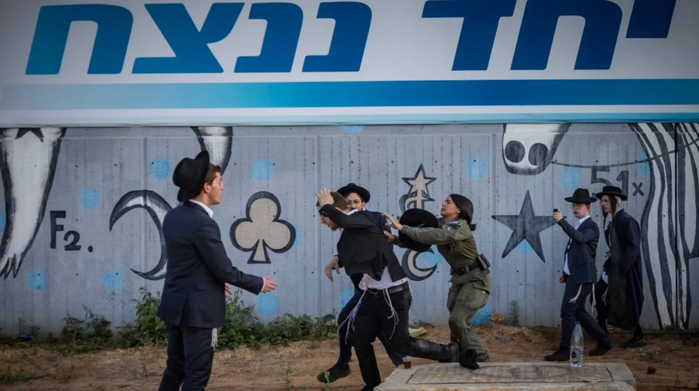 Ultra-Orthodox Jewish protesters demonstrate against the arrest of ultra orthodox jewish men who took part in a protest outside the home of Supreme Court Justice Noam Sohlberg and were later handed over to the military police, outside the Abu Kabir detention facility in Tel Aviv, June 10, 2026.
