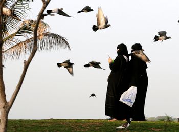 Saudi women use their phones at a public garden in Jeddah, Saudi Arabia, on March 8, 2021.