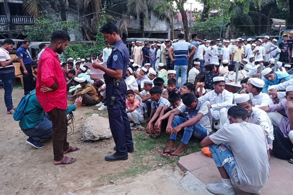 A policeman takes the details of Rohingya refugees at the Sadar Model police station in Cox's Bazar, Bangladesh, on May 4, 2022.