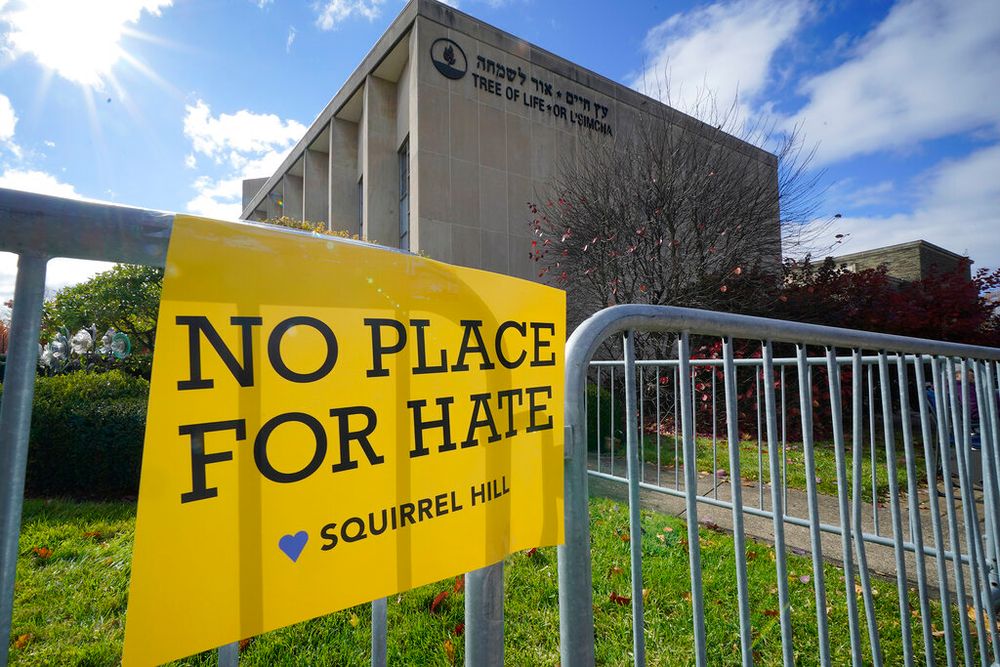 A sign hangs from a fence outside the dormant landmark Tree of Life synagogue in Pittsburgh's Squirrel Hill neighborhood, the United States.