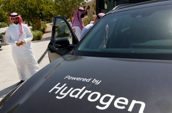 Saudis watch a hydrogen powered car during a test drive organized by Aramco, at the Techno Valley Science Park, in Dhahran, Saudi Arabia, June 27, 2021.