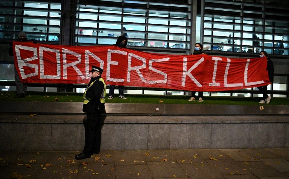 Protesters hold a banner reading "Borders Kill" as they demonstrate against the British Government's policy on immigration and border controls, in central London, United Kingdom, on November 25, 2021