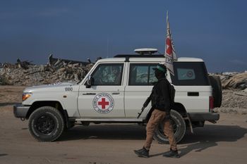 Hamas militants accompanied by members of the International Committee of the Red Cross (ICRC) head to east of Gaza City to search for the bodies of hostages, Thursday, Nov. 13, 2025