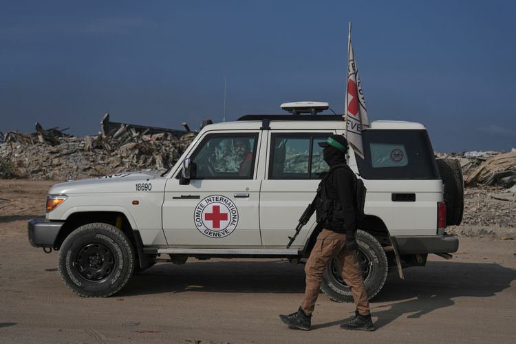 Hamas militants accompanied by members of the International Committee of the Red Cross (ICRC) head to east of Gaza City to search for the bodies of hostages, Thursday, Nov. 13, 2025