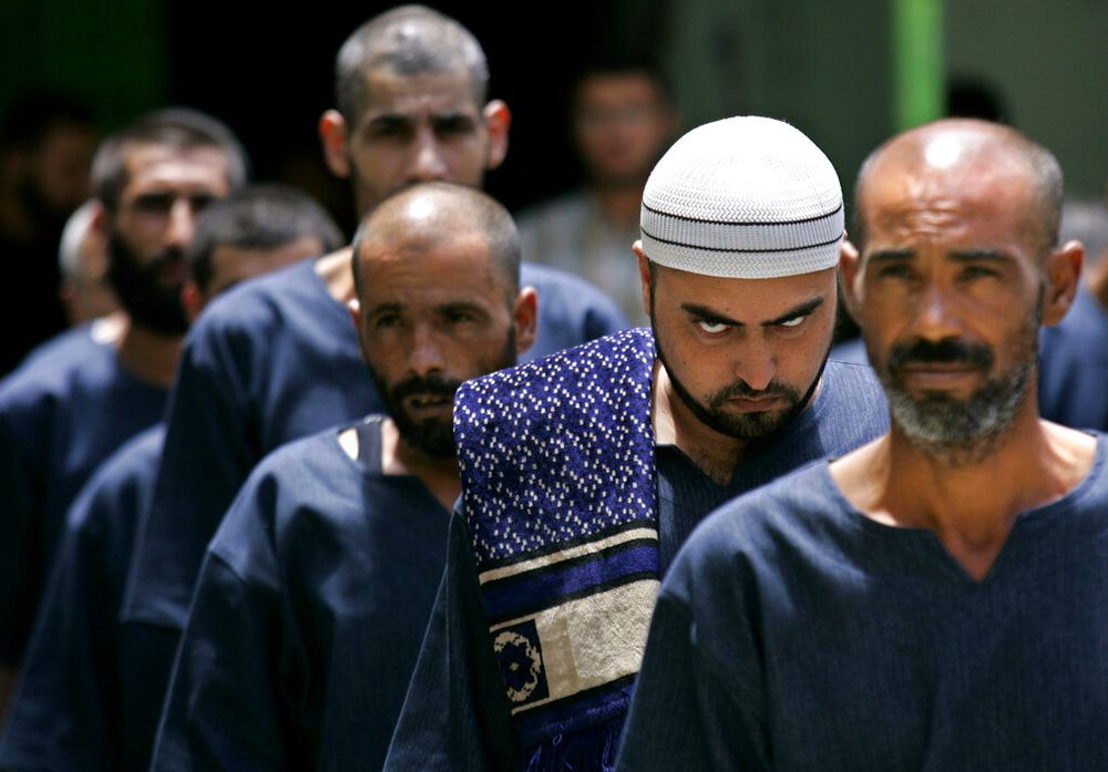 Palestinian prisoners line up at the Hamas-controlled Saraya prison in Gaza City, Gaza.