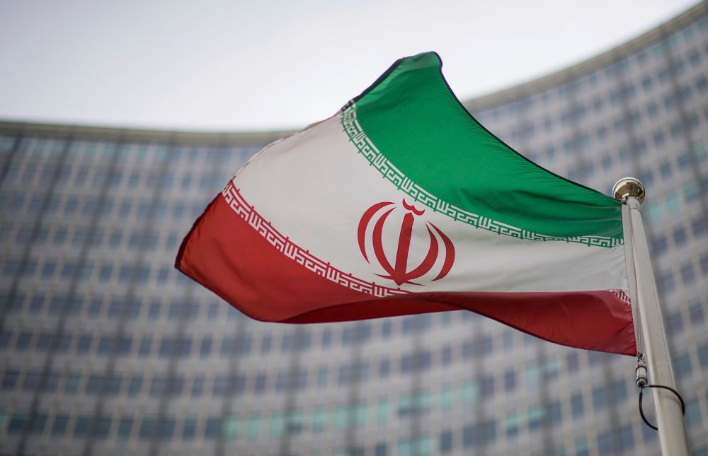 A national flag of Iran waves in front of the building of the International Atomic Energy Agency, IAEA, in Vienna, Austria, on December 17, 2021.