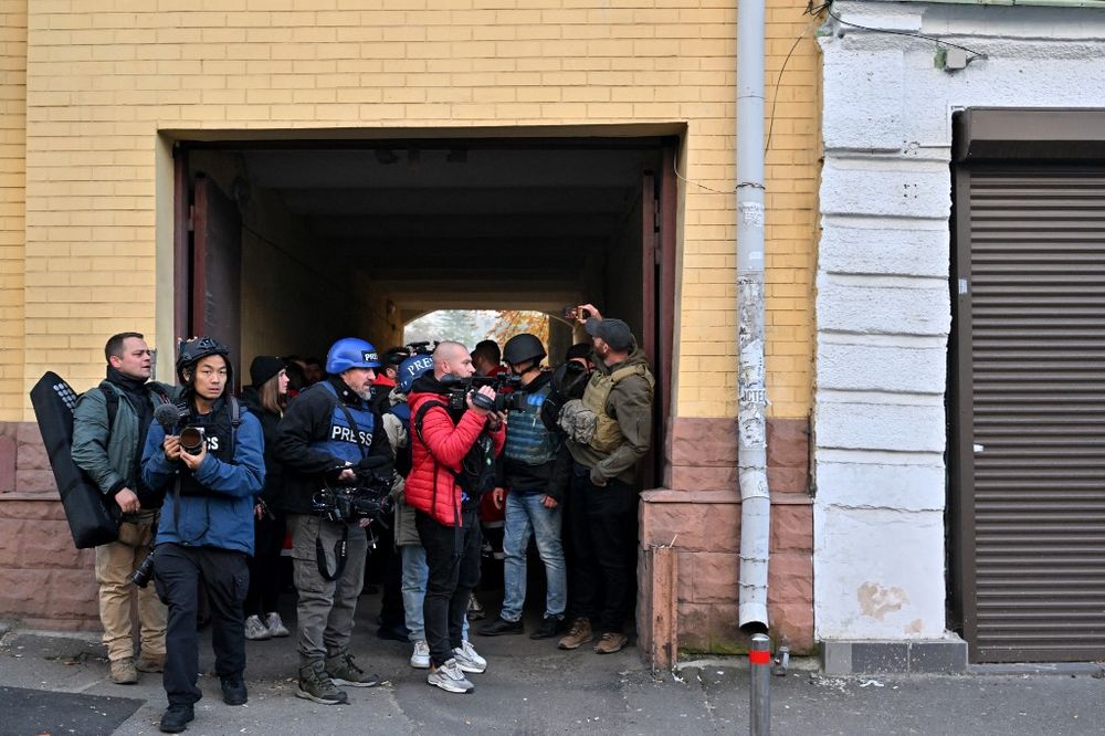 Journalists take shelter during a drone attack in Kyiv, Ukraine, amid the Russian invasion.