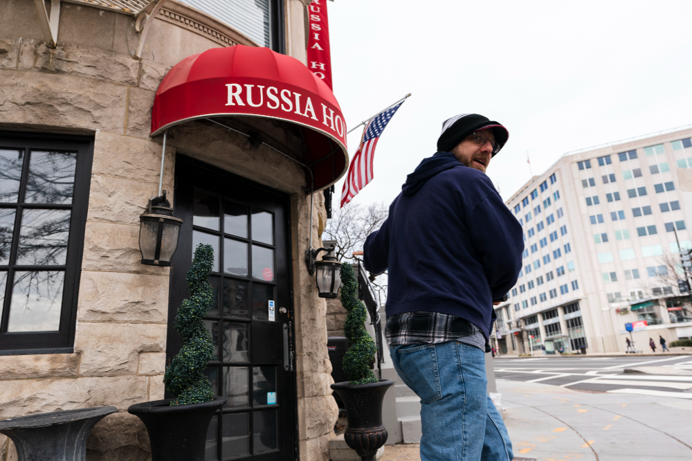 A passerby rides his scooter past the Russia House Restaurant and Lounge in northwest Washington, US, March 1, 2022.