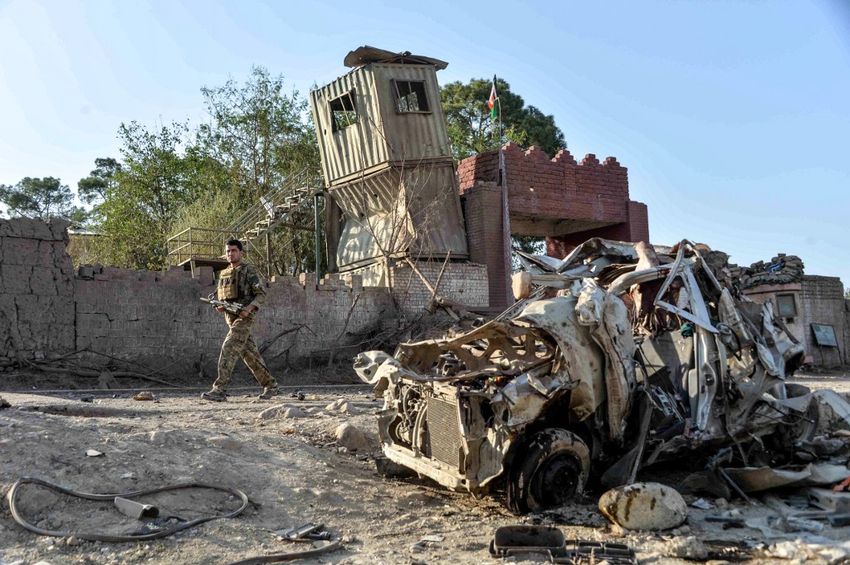 Afghan security personnel inspect the site of a car bomb attack that targeted a government building in Ghani Khel district of Nangarhar province on October 3, 2020.