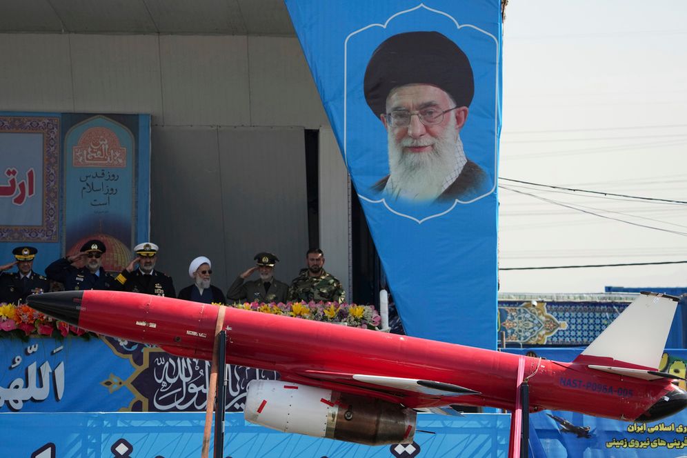 A drone is carried on a truck in front of a portrait of Iranian Supreme Leader Ayatollah Ali Khamenei just outside Tehran, Iran.