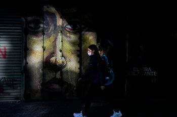 A pedestrian wears a mask due to the Covid pandemic in Santiago, Chile, on April 5, 2022.