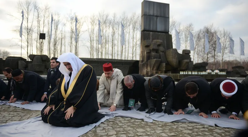 Mohammad al-Issa, secretary general of the Muslim World League and a former Saudi minister, leads prayers next to the memorial monument at Auschwitz-Birkenau, Jan. 23, 2020.
