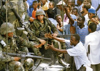 Haitians in 1994 reach out to American soldiers in gratitude after U.S. troops shut down the headquarters of FRAPH paramilitary political group in Port-au-Prince Haiti.