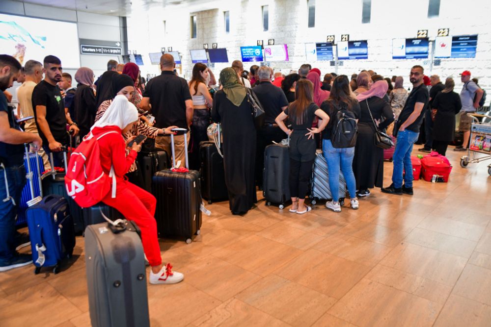 Travelers stand in line to check-in at Ben Gurion International Airport, central Israel, on June 14, 2022.